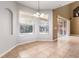 Bright dining area featuring tile floors, large windows overlooking pool, and modern lighting fixture at 2780 Running Springs Loop, Oviedo, FL 32765