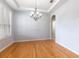 Bright dining room with hardwood floors, chandelier, and a large window for natural light at 2780 Running Springs Loop, Oviedo, FL 32765