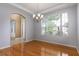 Open dining room with hardwood floors and a large window, showing a view of the neighborhood at 2780 Running Springs Loop, Oviedo, FL 32765