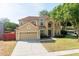Charming two-story home with a well-maintained lawn, a two-car garage, and a welcoming entrance at 2780 Running Springs Loop, Oviedo, FL 32765