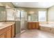 Bright bathroom with dual vanities, a glass-enclosed shower, and a soaking tub at 2780 Running Springs Loop, Oviedo, FL 32765