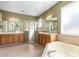 Bright and spacious bathroom with dual vanities, a glass-enclosed shower, and a soaking tub at 2780 Running Springs Loop, Oviedo, FL 32765
