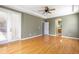 Comfortable primary bedroom features hardwood floors, a ceiling fan, and an ensuite bathroom at 2780 Running Springs Loop, Oviedo, FL 32765
