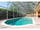 Screened-in pool area with a clear blue pool and ample space for lounging at 2780 Running Springs Loop, Oviedo, FL 32765