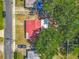 Aerial shot features a red-roofed house with surrounding greenery, showcasing its location relative to the street and nearby homes at 288 N Seneca St, Daytona Beach, FL 32114