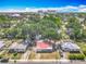 An aerial view captures the residential neighborhood with tree coverage and a red-roofed home in the center of the frame at 288 N Seneca St, Daytona Beach, FL 32114