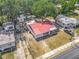 A bird's-eye view of the house showcasing its new red roof, and mature landscaping at 288 N Seneca St, Daytona Beach, FL 32114