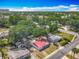 Aerial view of the home surrounded by mature trees, streets, and other homes in the neighborhood at 288 N Seneca St, Daytona Beach, FL 32114
