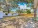 Large backyard with a mix of grass and sandy areas, partially enclosed by a wooden fence, offering a relaxing outdoor space at 288 N Seneca St, Daytona Beach, FL 32114