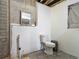 Incomplete bathroom shows a toilet, a mirror, a grey tiled floor and bare drywall at 288 N Seneca St, Daytona Beach, FL 32114