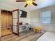 Bedroom featuring a desk, TV, and a bed with laminate flooring and a ceiling fan at 288 N Seneca St, Daytona Beach, FL 32114
