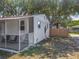 Back of house showing the screened-in porch, backyard, and privacy fence, perfect for outdoor enjoyment and relaxation at 288 N Seneca St, Daytona Beach, FL 32114