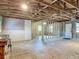 Partially finished garage featuring new framing, concrete walls, and plywood flooring at 288 N Seneca St, Daytona Beach, FL 32114