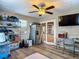 A living room featuring a refrigerator, shelving, and a ceiling fan with laminate flooring at 288 N Seneca St, Daytona Beach, FL 32114