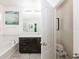 Bright bathroom featuring a soaking tub, dark wood vanity and separate toilet room at 2952 Boating Blvd, Kissimmee, FL 34746