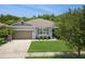 Well-maintained single story home with a 2 car garage, manicured lawn, and lovely landscaping at 2952 Boating Blvd, Kissimmee, FL 34746