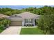 Well-maintained single story home with a 2 car garage, manicured lawn, and lovely landscaping at 2952 Boating Blvd, Kissimmee, FL 34746