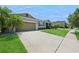 Beautiful single-story home featuring lush landscaping, driveway, and attached garage at 2952 Boating Blvd, Kissimmee, FL 34746
