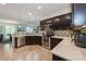 Spacious kitchen featuring stainless steel appliances, granite countertops, dark wood cabinets and mosaic backsplash at 2952 Boating Blvd, Kissimmee, FL 34746