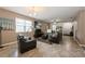 Open concept living room with comfortable seating, neutral paint, and tile flooring at 2952 Boating Blvd, Kissimmee, FL 34746