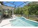 Inviting screened-in pool area with lush green surroundings offering a refreshing and tranquil outdoor oasis at 2952 Boating Blvd, Kissimmee, FL 34746