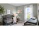 Charming Bedroom with crib, comfortable chair, soft lighting, and serene view, creating a peaceful environment at 33620 Seattle Slew Dr, Sorrento, FL 32776