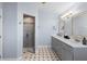 Bright bathroom featuring a double vanity and walk-in shower with neutral-colored tile at 3385 Lake Harney Cir, Geneva, FL 32732