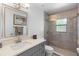 Updated bathroom with a gray vanity, walk-in shower with glass door, and decorative tile floor at 3385 Lake Harney Cir, Geneva, FL 32732