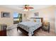 Inviting bedroom featuring a ceiling fan and a scenic view of the water at 3385 Lake Harney Cir, Geneva, FL 32732