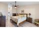 Relaxing bedroom with a ceiling fan, a bed with tropical patterned comforter, and wood furniture at 3385 Lake Harney Cir, Geneva, FL 32732