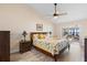 Light and airy bedroom featuring water views, ceiling fan, vaulted ceilings and comfy bedding at 3385 Lake Harney Cir, Geneva, FL 32732