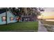 Charming lakeside home with a screened lanai and lush lawn, perfect for enjoying serene sunset views at 3385 Lake Harney Cir, Geneva, FL 32732