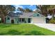 Charming home featuring a lush lawn, freshly-painted trim, and an attached two-car garage at 3385 Lake Harney Cir, Geneva, FL 32732