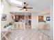 Bright living area showing an open floor plan with skylight and access to the bar and kitchen at 3385 Lake Harney Cir, Geneva, FL 32732