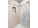 Walk-in shower features neutral tile, built-in niche, and glass door at 3385 Lake Harney Cir, Geneva, FL 32732