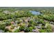 Aerial view of a neighborhood showcasing homes, lush greenery, and a serene lake at 343 Raleigh Pl, Oviedo, FL 32765