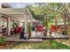 Backyard featuring a covered patio with furniture, a lush lawn, and beautiful landscaping at 343 Raleigh Pl, Oviedo, FL 32765