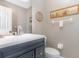 This bathroom features a vanity with a dark cabinet, a white countertop and toilet at 343 Raleigh Pl, Oviedo, FL 32765