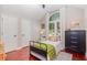 Bedroom with sleek wood floors, a high ceiling, and a window with bright sunlight at 343 Raleigh Pl, Oviedo, FL 32765