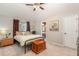 Bedroom featuring neutral colors, comfy bed, ceiling fan, and a door to the bathroom at 343 Raleigh Pl, Oviedo, FL 32765