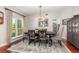 Inviting dining room with dark wood table and a large window at 343 Raleigh Pl, Oviedo, FL 32765