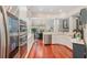 Modern kitchen featuring stainless steel appliances, white cabinets, and hardwood floors at 343 Raleigh Pl, Oviedo, FL 32765