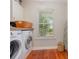 Bright laundry room with wooden countertops, large window, washer, and dryer at 343 Raleigh Pl, Oviedo, FL 32765