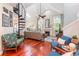 Bright open living room with high ceilings, spiral staircase, fireplace, and wood floors at 343 Raleigh Pl, Oviedo, FL 32765