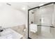 Modern bathroom featuring a glass-enclosed shower, sink with vanity, and neutral tile at 4604 S Shore Rd, Orlando, FL 32839