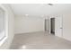 Bright, spacious room with wood-look flooring, neutral walls, and a doorway to another room at 4604 S Shore Rd, Orlando, FL 32839