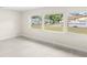 Well-lit room with light wood-look floors, neutral walls, and multiple windows offering a view at 4604 S Shore Rd, Orlando, FL 32839