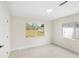 Bright bedroom with modern flooring, neutral walls, and a view of the outdoors through the windows at 4604 S Shore Rd, Orlando, FL 32839