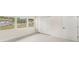 Bright bedroom featuring wood-look flooring, a closet, white paneled door, and outdoor views at 4604 S Shore Rd, Orlando, FL 32839