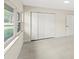 Bright room showcasing wood-look floors, a window, a closet, and a white paneled door at 4604 S Shore Rd, Orlando, FL 32839